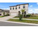 Two-story house with a white exterior, two-car garage, and landscaping at 14786 Horse Trot Rd, Lithia, FL 33547