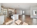 Open concept kitchen and living area with hardwood floors at 1742 W Saint Louis St, Tampa, FL 33607