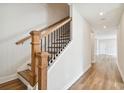 Wooden staircase with black metal accents and hardwood floors at 1742 W Saint Louis St, Tampa, FL 33607