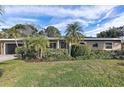 Single story home with landscaping and attached garage at 219 57Th S Ave, St Petersburg, FL 33705