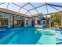 Inviting screened-in pool area with plenty of seating at 3457 Foxhall Dr, Holiday, FL 34691