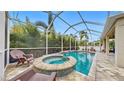 Screened pool and spa with lounge chairs and a spacious patio at 5230 Admiral Pointe Dr, Apollo Beach, FL 33572