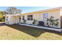 Light yellow ranch home with a neatly landscaped yard and updated exterior at 6554 34Th N Ave, St Petersburg, FL 33710