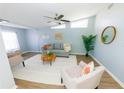 Bright living room featuring light walls, wood floors, and cozy seating at 6554 34Th N Ave, St Petersburg, FL 33710