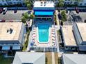 An apartment complex pool with lounge chairs and a surrounding patio at 6915 Avenue Des Palais # 2B, South Pasadena, FL 33707