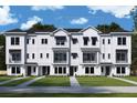 Three story modern townhome with white exterior at 7408 Newham Ln, Sarasota, FL 34240