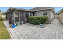 Screened patio with paver stones and landscaping at 10405 White Peacock Pl, Riverview, FL 33578