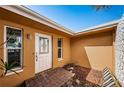 Front entrance with white door and brick walkway at 11650 4Th E St, Treasure Island, FL 33706