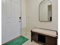 Bright entryway with white door, bench, and a mirror at 13355 Orca Sound Dr, Riverview, FL 33579