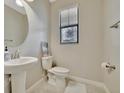 Clean powder room with pedestal sink and toilet at 13355 Orca Sound Dr, Riverview, FL 33579