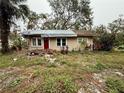 Tan single story house needing repairs, with damaged roof and landscaping at 1602 Saffold Park Dr, Ruskin, FL 33570