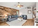 Living room features a wood-look wall and gray couch at 1610 Allenton Ave, Brandon, FL 33511