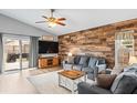 Living room with a wood-look accent wall and sliding doors at 1610 Allenton Ave, Brandon, FL 33511