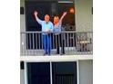 Couple enjoying their balcony overlooking the ocean at 1660 Gulf Blvd # Ph1, Clearwater Beach, FL 33767