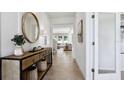 Bright and spacious entryway with a console table and mirror at 32465 Osprey Peak Way, San Antonio, FL 33576