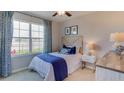 Cozy bedroom with blue accents and water views at 32763 Osprey Peak Way, San Antonio, FL 33576