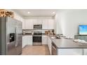 Modern kitchen with stainless steel appliances and gray countertops at 33217 Osprey Peak Way, San Antonio, FL 33576