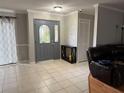 Inviting entryway with tiled floors and a gray front door at 3544 Snowy Egret Ct, Palm Harbor, FL 34683