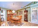 Charming dining room with a wooden table and chandelier at 38902 Inez Ave, Zephyrhills, FL 33542