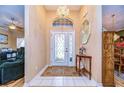 Elegant entryway with a glass door and tiled floor at 38902 Inez Ave, Zephyrhills, FL 33542