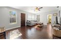 Living room featuring hardwood floors, comfy sofa and large windows at 4424 W Bay Villa Ave, Tampa, FL 33611