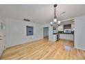 Bright dining room with hardwood floors and kitchen views at 4619 W Bay Villa Ave, Tampa, FL 33611