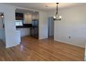 Bright kitchen with white cabinets, stainless steel appliances, and hardwood floors at 4619 W Bay Villa Ave, Tampa, FL 33611