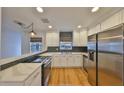 Modern kitchen with white cabinets and stainless steel appliances at 4619 W Bay Villa Ave, Tampa, FL 33611