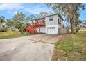 Two-story house with a deck, garage, and fenced yard at 5004 Osprey Ln, New Port Richey, FL 34652