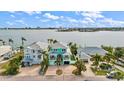 Aerial view of waterfront home with private dock and boat lift at 644 Boca Ciega Isle Dr, St Pete Beach, FL 33706