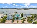 Three waterfront homes with driveways, landscaping, and water views at 644 Boca Ciega Isle Dr, St Pete Beach, FL 33706