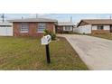 Brick home with a driveway and well-maintained lawn at 6950 113Th St, Seminole, FL 33772