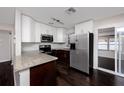 Modern kitchen with stainless steel appliances and dark wood cabinets at 7449 16Th N St, St Petersburg, FL 33702