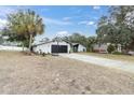 Spacious home with a long driveway, basketball hoop and mature trees at 8237 Delaware Dr, Weeki Wachee, FL 34607