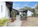 Modern home exterior with walkway, landscaping, and unique architectural details at 8237 Delaware Dr, Weeki Wachee, FL 34607