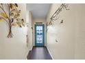 Interior entryway with teal door and hardwood floor at 8615 Carroll Oaks Dr, Tampa, FL 33614