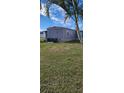 Side view of manufactured home with AC unit and lawn at 103 E Saint Lucia Loop, Apollo Beach, FL 33572