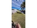 Backyard view of home with grassy area and canal at 103 E Saint Lucia Loop, Apollo Beach, FL 33572