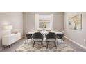 Formal dining room with a six-person table and modern sideboard at 10550 Bridgegate Heights Loop, San Antonio, FL 33576