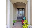 Inviting front entry with a charming bench and lush greenery at 10804 Wicker Park Pl, Palmetto, FL 34221