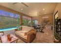 Outdoor kitchen and seating area overlooking a refreshing pool at 10804 Wicker Park Pl, Palmetto, FL 34221