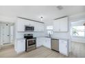 Renovated kitchen, white cabinets, stainless steel appliances at 10821 Freedom Blvd, Seminole, FL 33772