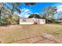 Mobile home with a brown deck, ample yard space, and surrounding trees at 12914 Gordon Rd, Riverview, FL 33579