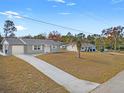 Property view showing a house with a driveway and surrounding landscape at 13178 Thrush St, Spring Hill, FL 34609