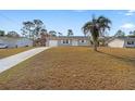 Single story house with a gray exterior, white shutters, and a palm tree at 13178 Thrush St, Spring Hill, FL 34609