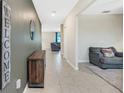 Bright entryway with tile floors, a console table, and views into the living room at 13614 Wild Ginger St, Riverview, FL 33579