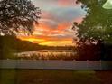 Scenic sunset view over a tranquil lake from the backyard at 1415 Mohrlake Dr, Brandon, FL 33511