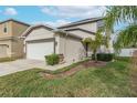 Two-story house with attached garage and well-manicured lawn at 1966 Hawks View Dr, Ruskin, FL 33570