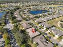 Property location shown from above with neighboring houses and a golf course nearby at 2124 Sifield Greens Way # 11, Sun City Center, FL 33573