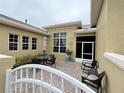 Brick patio with seating area, and access to screened porch at 2124 Sifield Greens Way # 11, Sun City Center, FL 33573